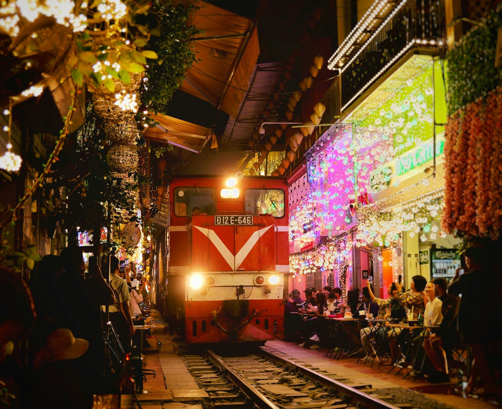 A train passing close to cafes on Hanoi Train Street