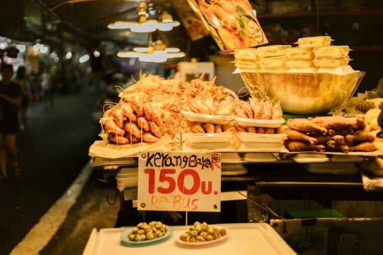 Street food market stall in Thailand with a variety of local dishes