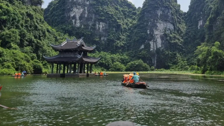 Boats on the river beneath limestone karsts in Ninh Binh, Vietnam