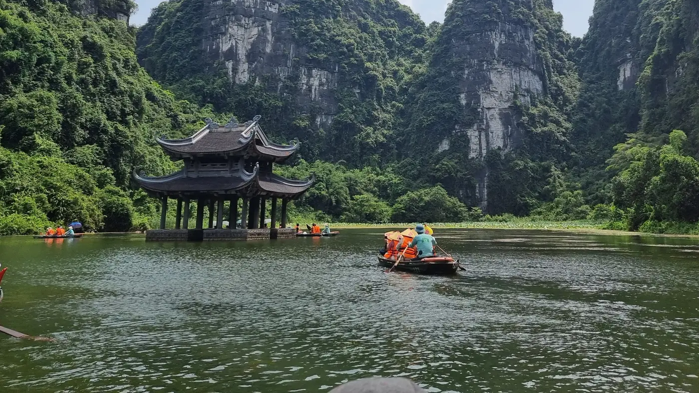 Boats on the river beneath limestone karsts in Ninh Binh, Vietnam