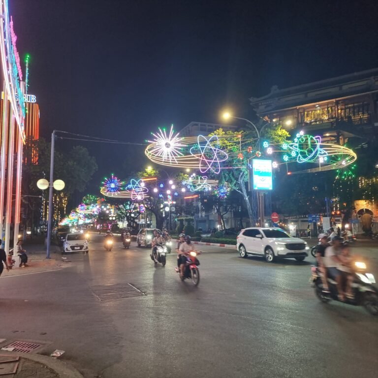 Motorbikes and cars beneath decorative street lights in Can Tho, southern Vietnam